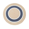 A round rug with concentric circular stripes in natural beige, navy blue, and white.