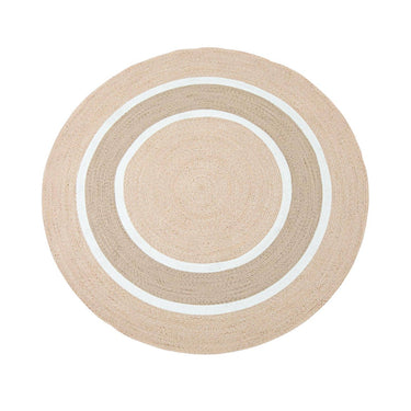 A round rug with concentric circular stripes in natural, beige  and white.