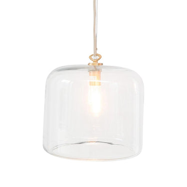 Clear glass dome pendant light with a warm glowing bulb inside and a small brass-toned top cap, suspended.