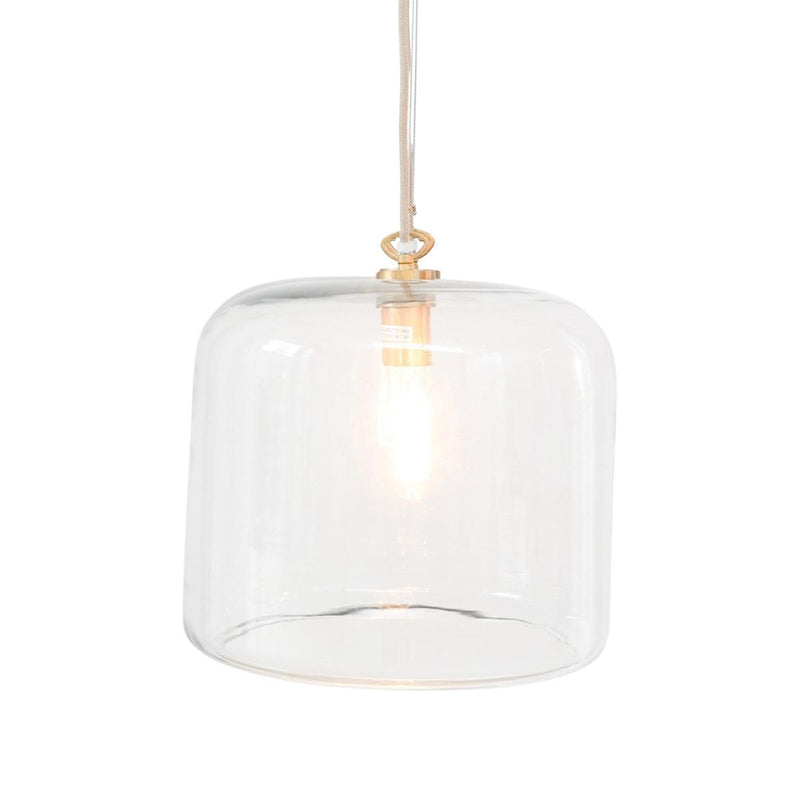 Clear glass dome pendant light with a warm glowing bulb inside and a small brass-toned top cap, suspended.