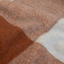 Close up texture of the traditional tartan check block pattern on the wool-blend Knightsbridge Cognac throw blanket.