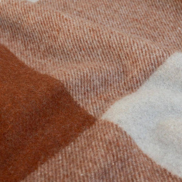 Close up texture of the traditional tartan check block pattern on the wool-blend Knightsbridge Cognac throw blanket.