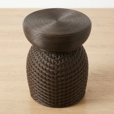 Dark brown woven wicker accent table with a round, ribbed top.