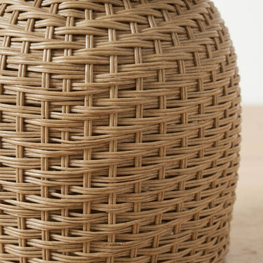 woven wicker design of the koko ratan side table in tan.