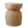 A natural woven rattan side table with a round slatted top and a textured cylindrical base.