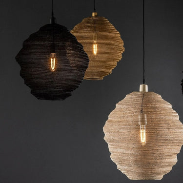 Three hanging pendant lights in spherical mesh shades in black, gold and beige, shown against a dark background.