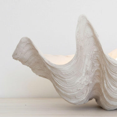 Detailed view of the intricate natural texture and weathered-look finish on a large resin clam shell.