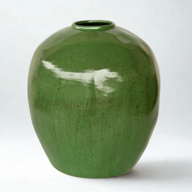 Large green ceramic vase with round silhouette