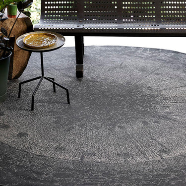 Durable dichotomized slate round rug with organic tree-inspired pattern