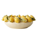Decorative bowl with yellow lemons and green leave decorative elements