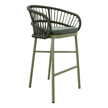 Lola modern outdoor bar stool with a curved backrest made of dark woven rope, cushioned seat, and a light sage green metal frame.