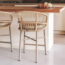 Two outdoor counter chairs in a kitchen setting with a wooden counter.