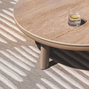 Lookout outdoor rug in a warm clay tone, showing a detailed geometric cross-hatch weave under patio furniture.