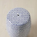 Top view of the blue and white ceramic stool showing the smooth circular surface and decorative border