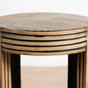 A close-up of geometric striped pattern in natural wood and black.