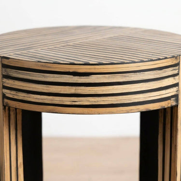 A close-up of geometric striped pattern in natural wood and black.