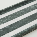 Close-up of marble bathroom tray showing green and white marble veining
