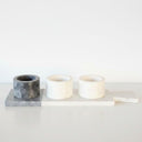 Three marble pinch pots on a two-tone marble board
