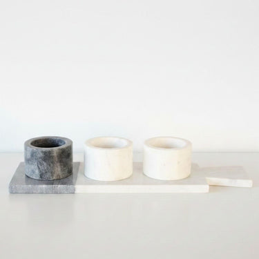 Three marble pinch pots on a two-tone marble board
