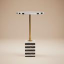 Black and white striped marble side table with brass stem