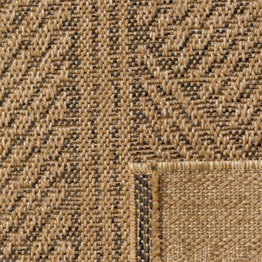 Textured detail of Marcus outdoor rug showing the modern herringbone-style weave and subtle black lines.