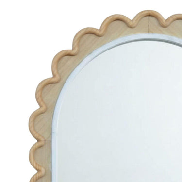 Close-up of arched mirror detail showcasing the decorative scalloped wood grain texture and crisp white border
