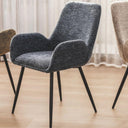 Upholstered dining room chair for with black legs on a wooden floor