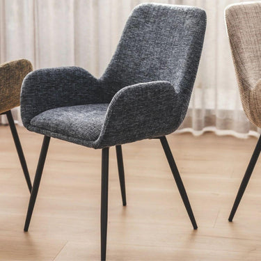 Upholstered dining room chair for with black legs on a wooden floor