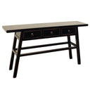 Detailed angled view of the black solid elmwood console table highlighting its modern organic luxury and lived-in finish