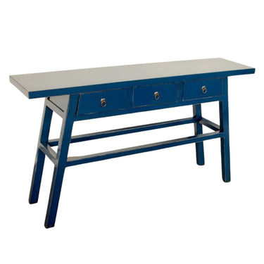 Rich blue finish and drawer hardware on the distressed elmwood texture of the Maya console by Woodka Interiors.