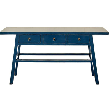 Deep blue Maya console table with a timeworn aesthetic and three drawers featuring vintage brass ring pulls