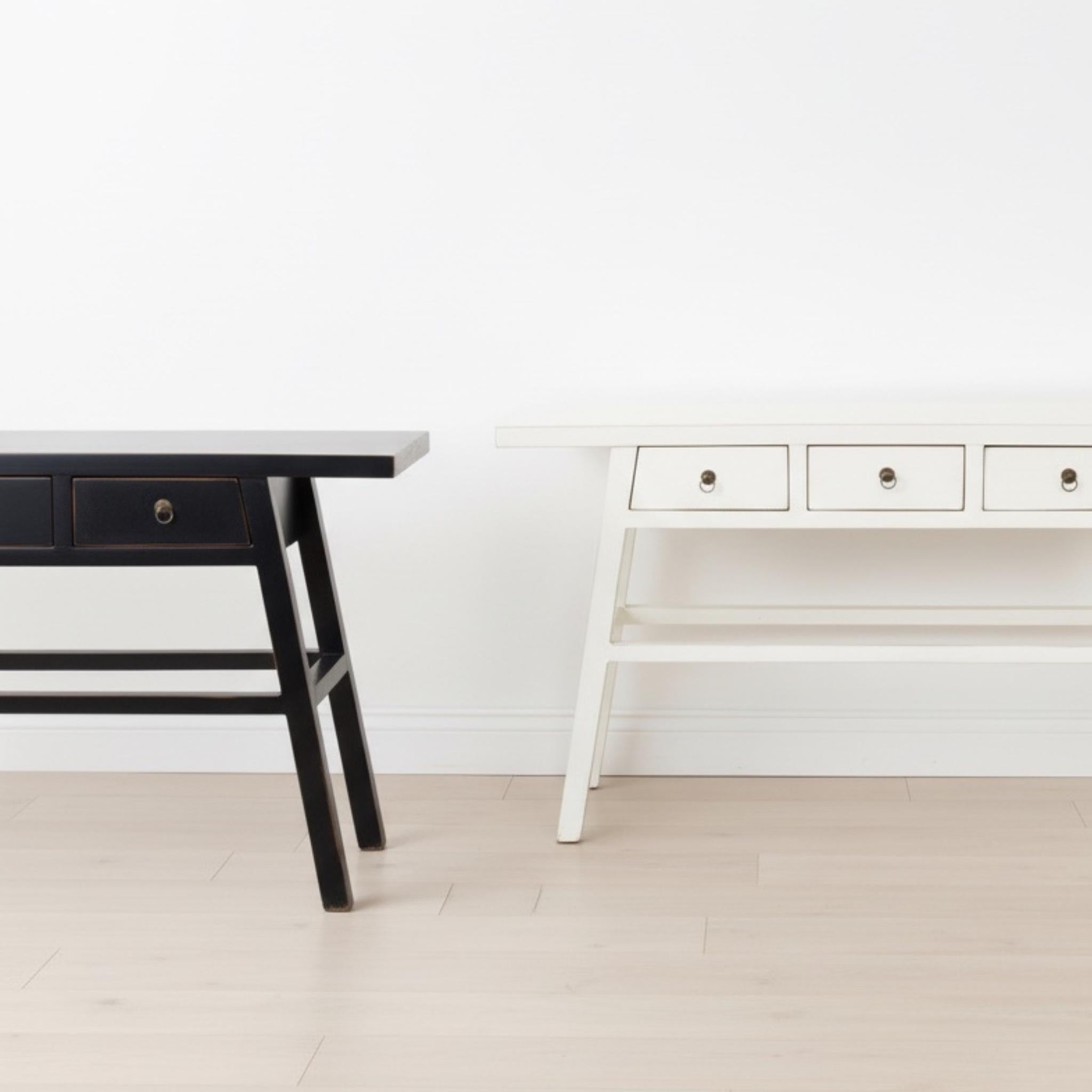 The Maya Console Table in black or white is crafted from solid elmwood with a beautifully distressed finish styled together