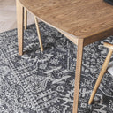 Memoir Rug in Ink Pen, in deep ink- tones and timeless pattern against light wood flooring.