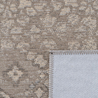 Detailed view of the silvery grey and brown muted tones on a flat-weave recycled polyester rug