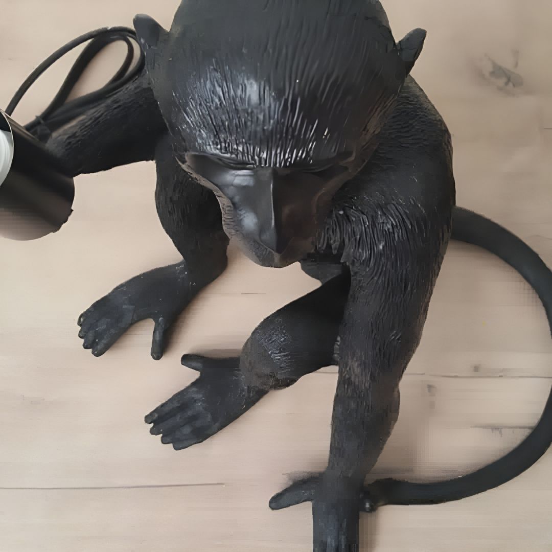 a statue monkey table lamps sitting 