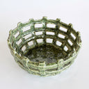 Moss green ceramic weave bowl with chunky open work lattice weave and speckled moss green glossy glaze top view.