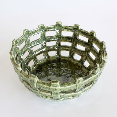 Moss green ceramic weave bowl with chunky open work lattice weave and speckled moss green glossy glaze top view.