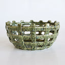 ceramic basketweave bowl with a textured, speckled green glaze, photographed on a clean white background.