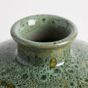 Mottled green ceramic vase with a wide round shape and short flared neck, glazed in layered shades of green
