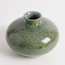 Mottled green ceramic vase with a wide round shape and short flared neck, glazed in layered shades of green