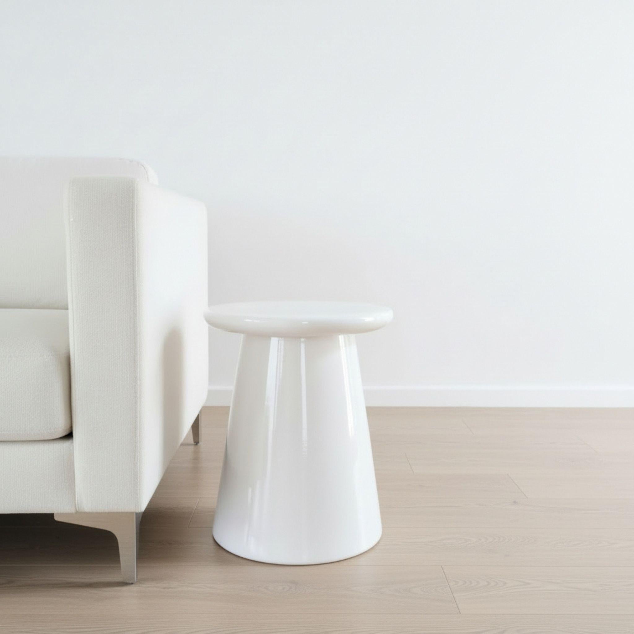 White Nova Side Table styled as a modern round ceramic side table in living room