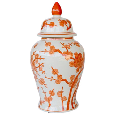 A ceramic ginger jar with a glossy finish and delicate orange blossom designs.