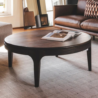 Summerhouse Coco coffee table styled in a modern living room next to a couch.
