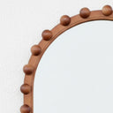 The Orla Arched Mirror with wooden ball accents 
