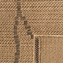 Close-up texture of Palau tribal geometric rug featuring black line accents on a neutral wicker background.