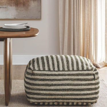 paralla square striped ottoman in neutral beige and charcoal  in a dining room.