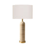 travertine table lamp with a cylindrical e base, a brass gold-finished neck and bottom cap, and a large white drum shade.