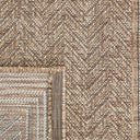 Close-up view of the Pogo runner rug showing its tight, low-profile polypropylene flat-weave texture and herringbone pattern in natural straw tones.