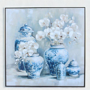 Framed canvas print with blue and white porcelain jars and white orchid flowers and subtle hand-finished texture