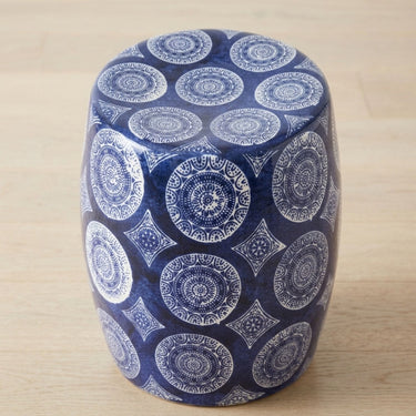 Blue and white ceramic stool with intricate medallion pattern.